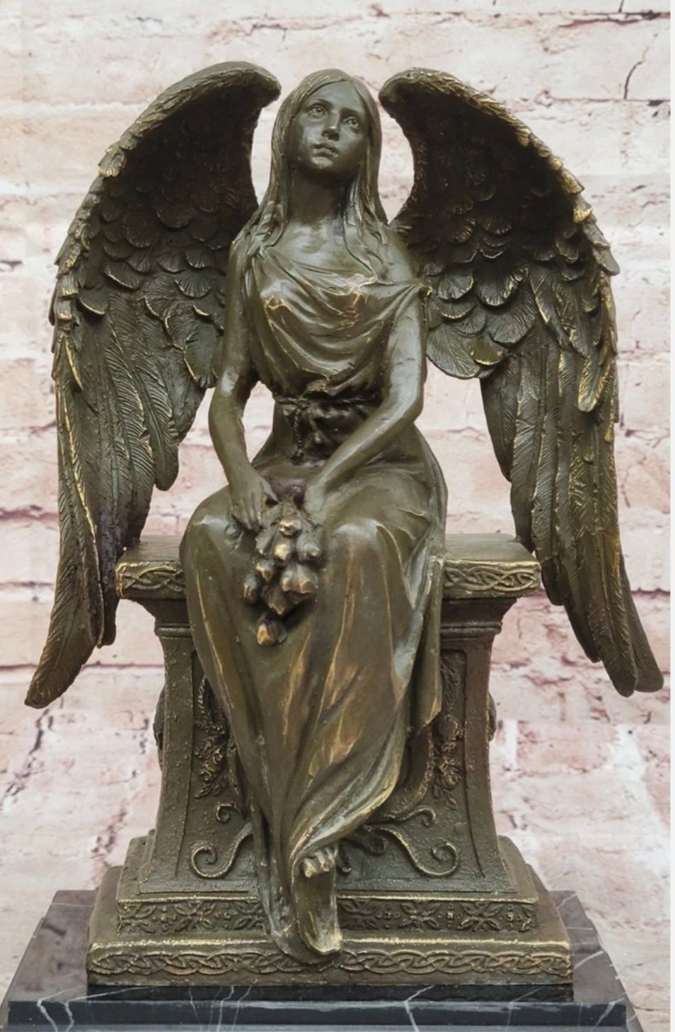 Bronze Angel with Roses Sitting on a Tombstone