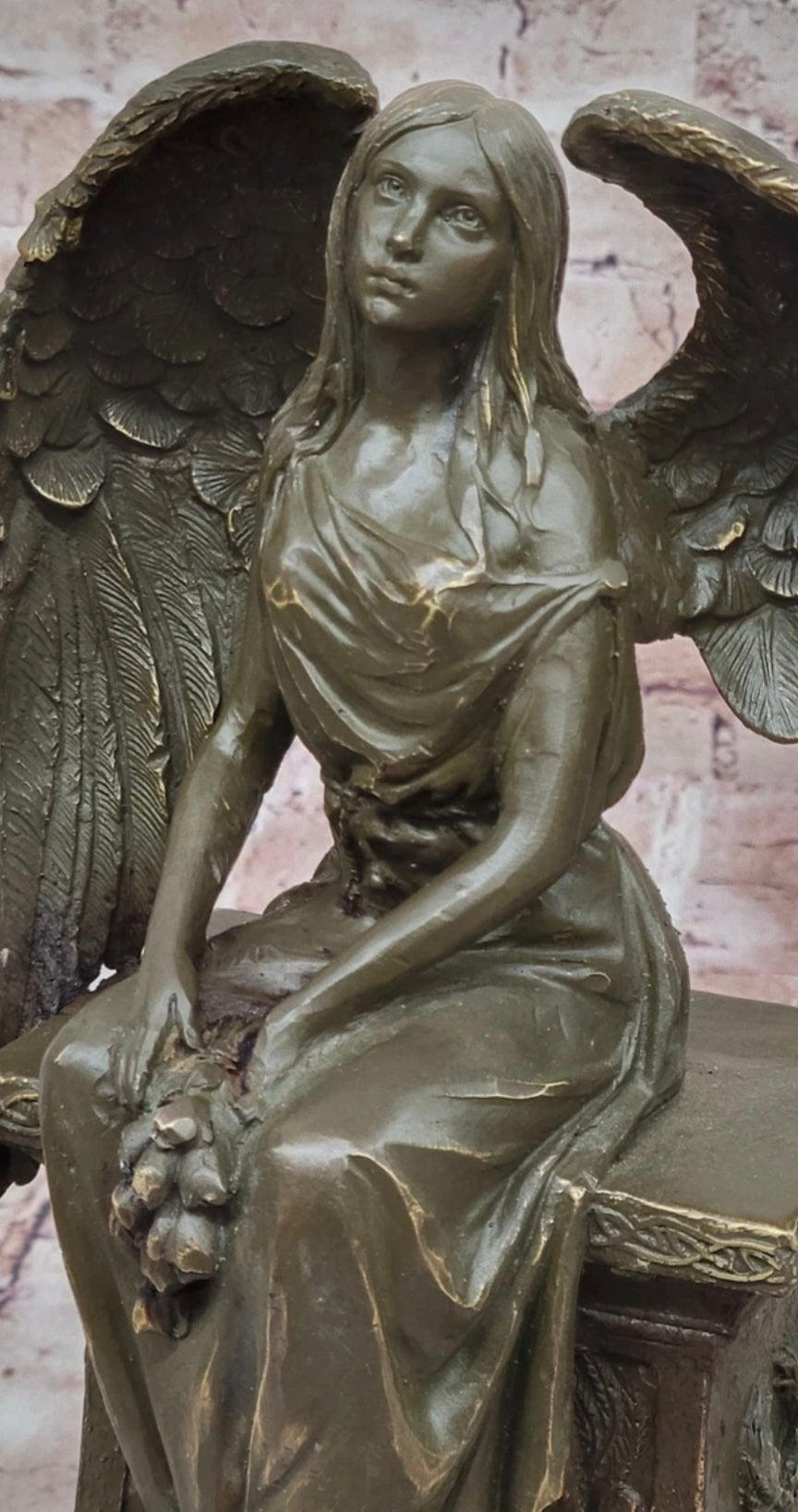 Bronze Angel with Roses Sitting on a Tombstone