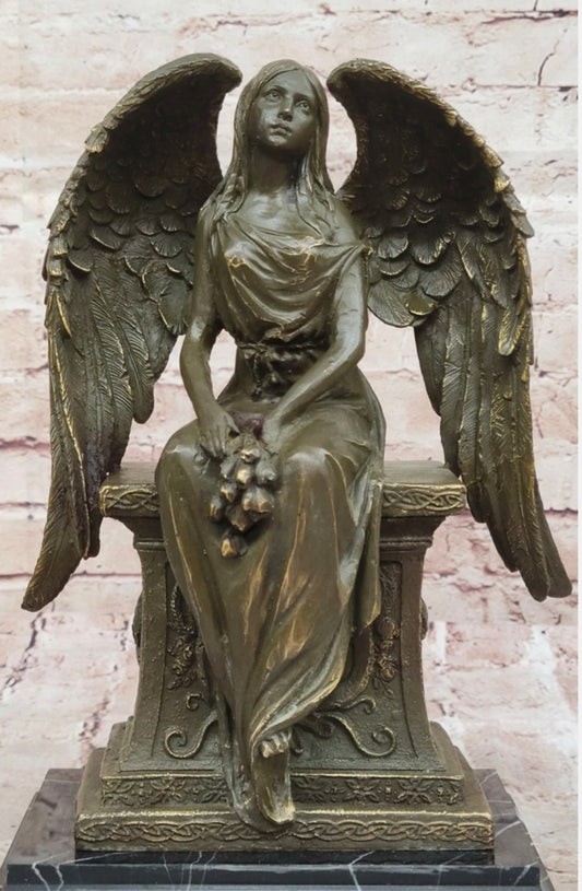 Bronze Angel with Roses Sitting on a Tombstone