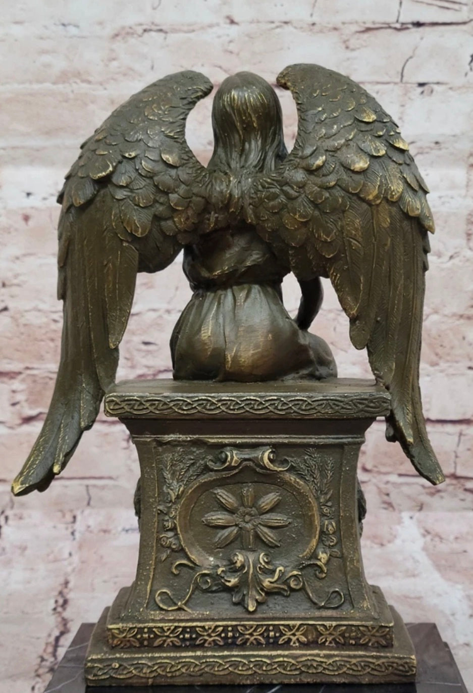 Bronze Angel with Roses Sitting on a Tombstone