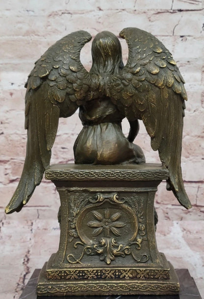 Bronze Angel with Roses Sitting on a Tombstone