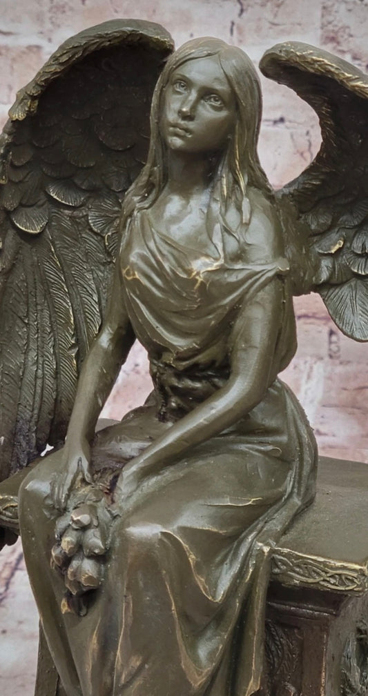 Bronze Angel with Roses Sitting on a Tombstone